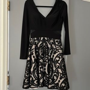 Beautiful black out mesh lined minidress worn once. Runs a bit small